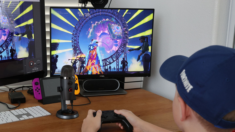 A person playing Fortnite on a computer monitor