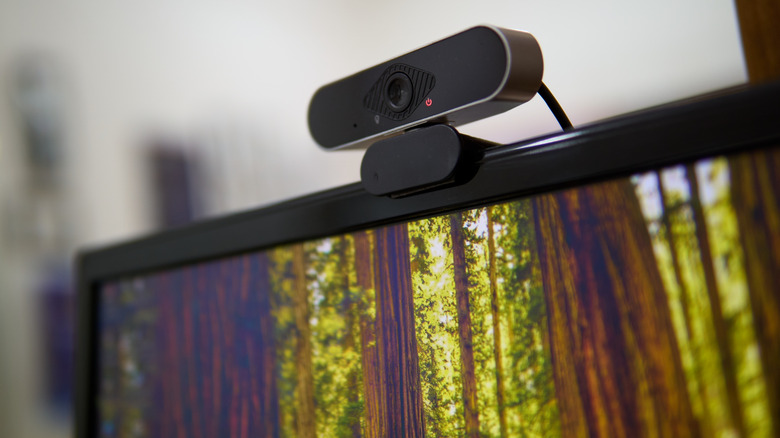 A webcam perched on top of a display