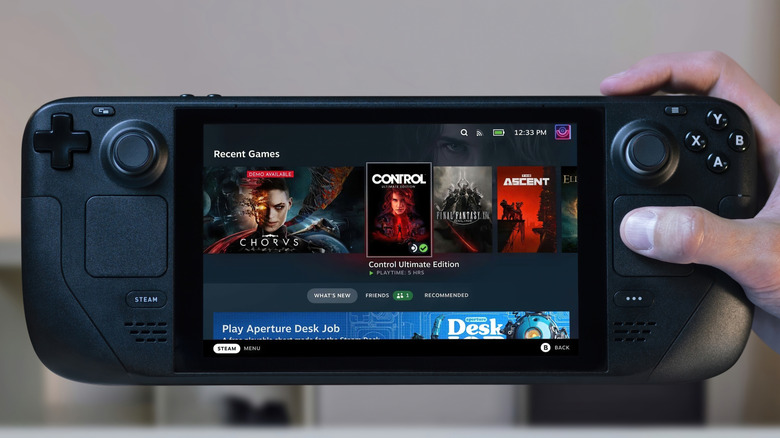 A person holding a Steam Deck with the Recent Games screen open
