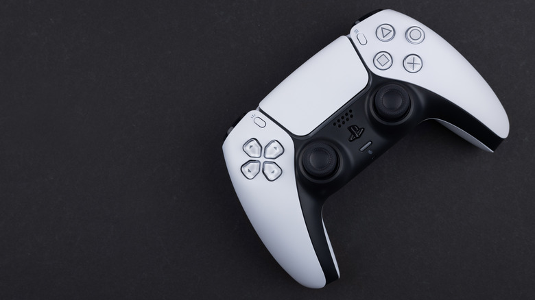 A photograph of a DualSense PS5 controller on a black background.
