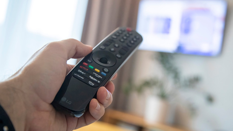 Hand pointing remote at LG TV