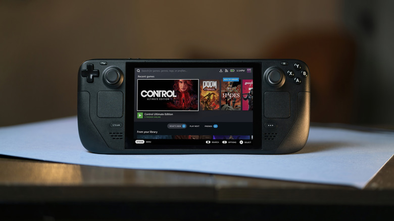 Steam Deck propped up on a desk with screen on.