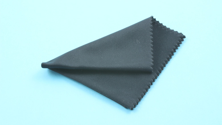 Black microfiber cloth on blue background