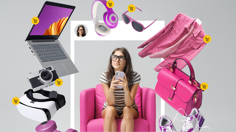 Woman holding phone while surrounded with items to add to cart