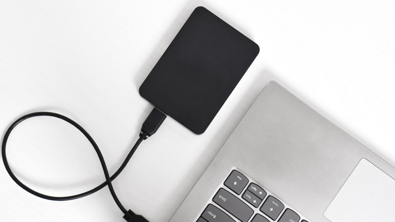 A hard drive connected to a laptop