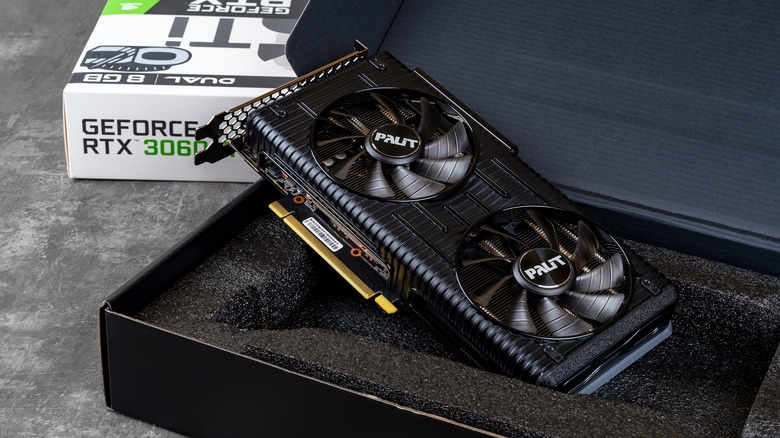 A Geforce RTX 3060 sitting on top of the packaging foam as it if was freshly opened from the box, the GPU tilts against its box to show the photo was staged