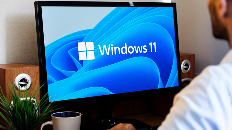 a man working on a computer that says Windows 11