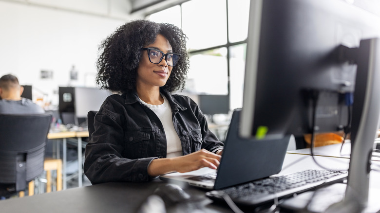 a woman in an office working on your computer