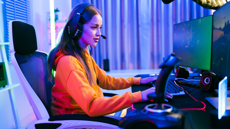 a woman playing a video game on her computer