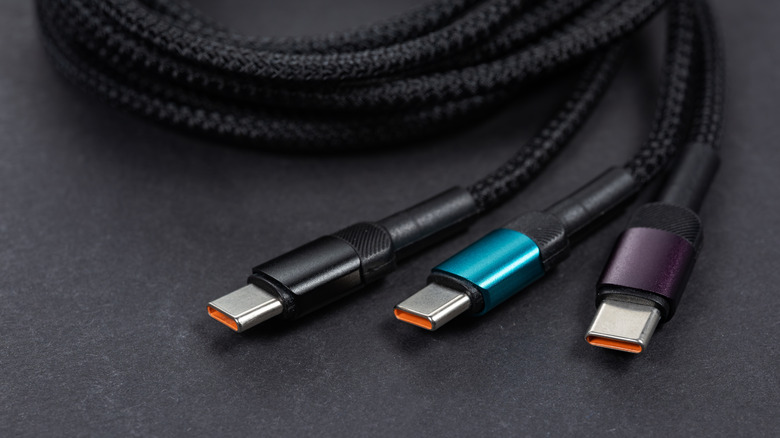 Three braided USB-C cables on a dark surface