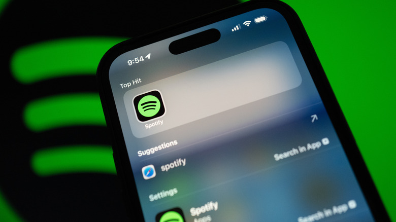 A close-up of the Spotify app badge displayed on an iPhone