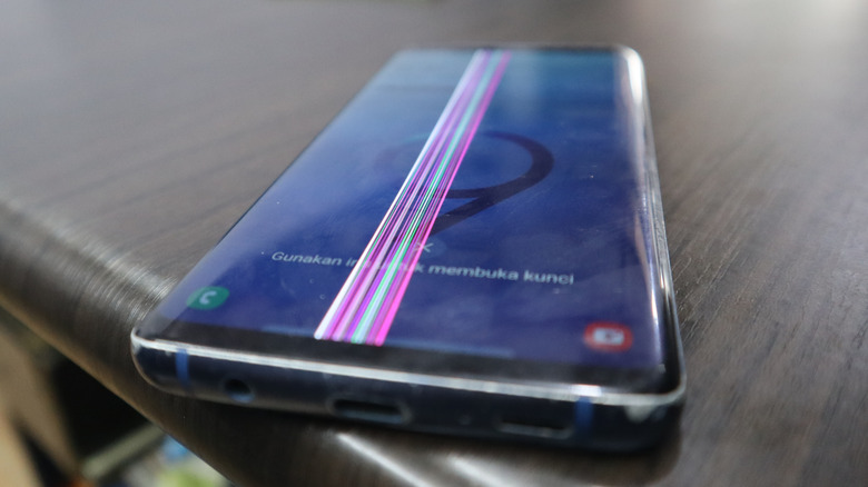Faulty phone display showing a thick pink line.