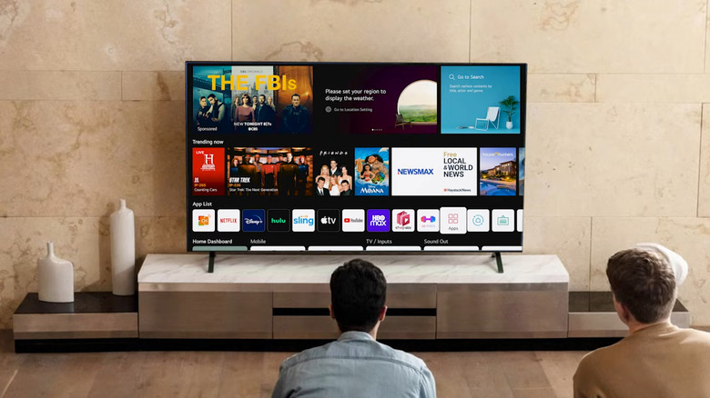Two men using LG TV in the living room