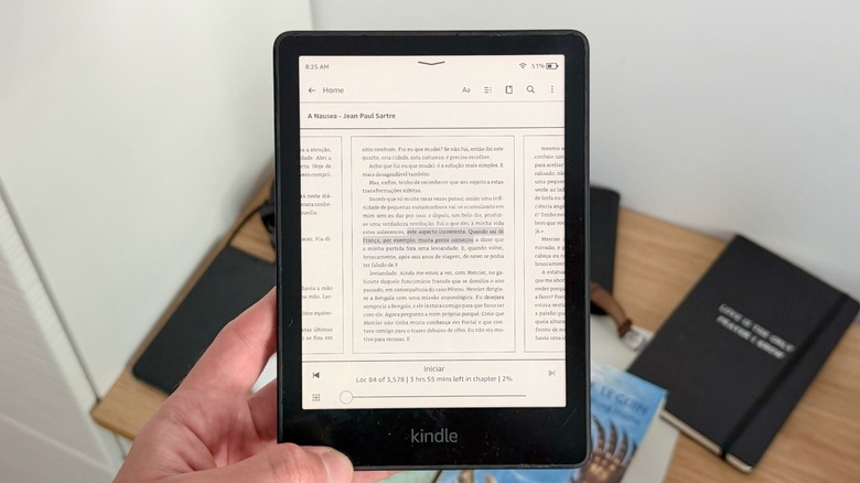 A hand holding an Amazon Kindle Paperwhite