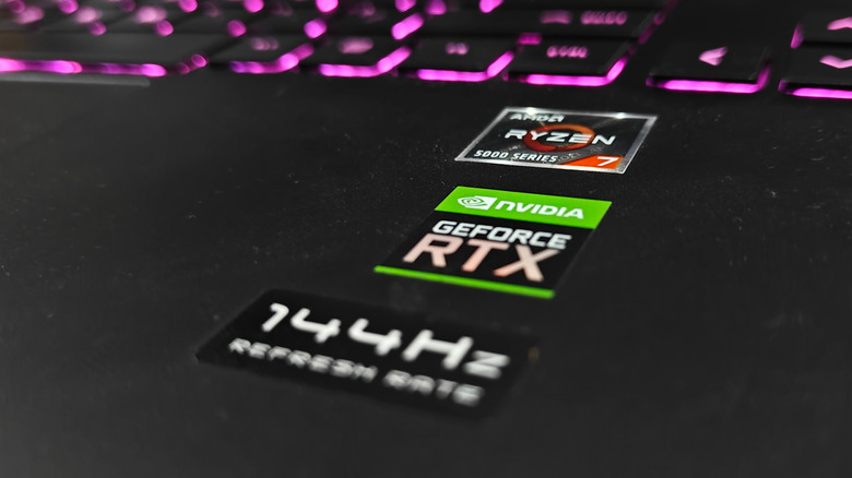AMD Ryzen, Nvidia GeForce RTX, and 144Hz refresh rate stickers on a gaming laptop with backlit keys.