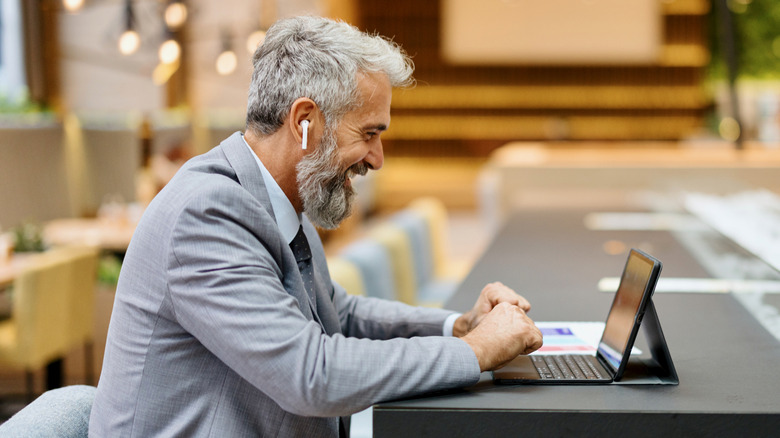 A man with AirPods engaged in a conversation.