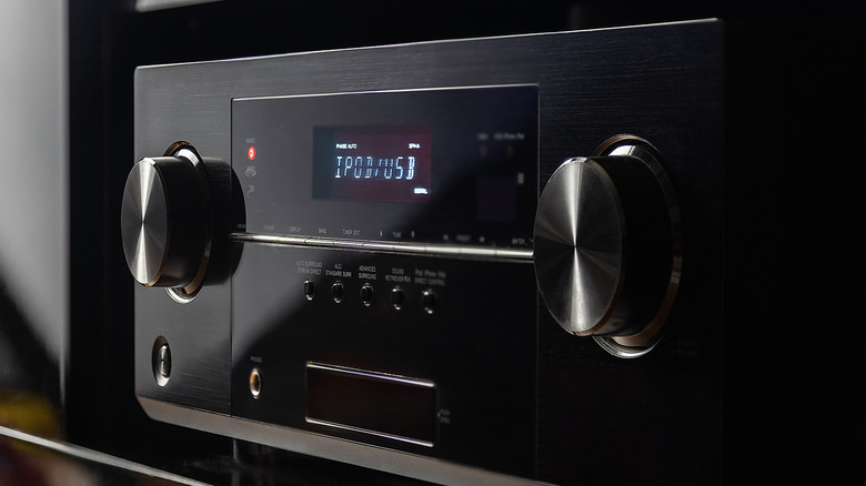 An AV receiver placed on an entertainment center.