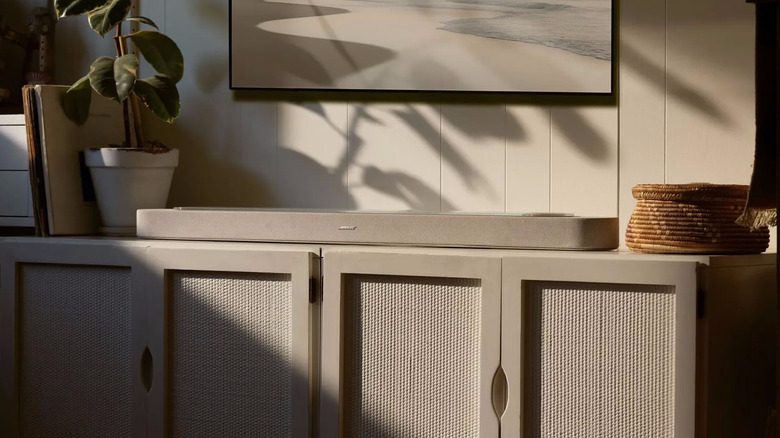 A Bose soundbar sitting on a media stand
