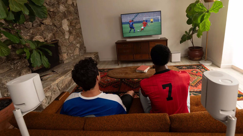 A pair of Bose Lifestyle Collection speakers sitting behind a couch