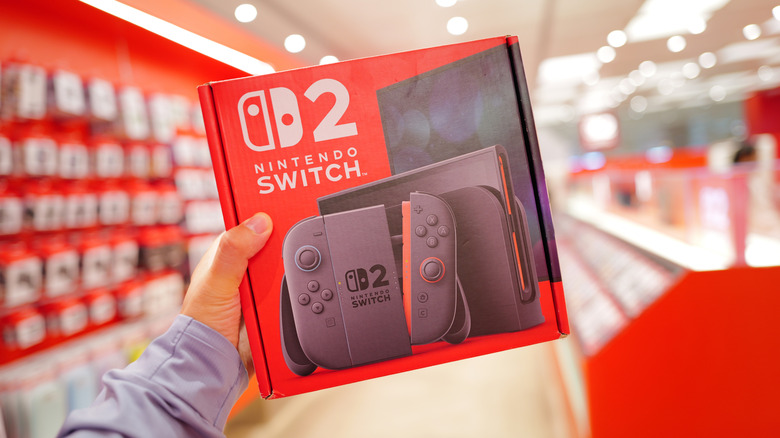 Buyer holding a new Nintendo Switch 2 in a store