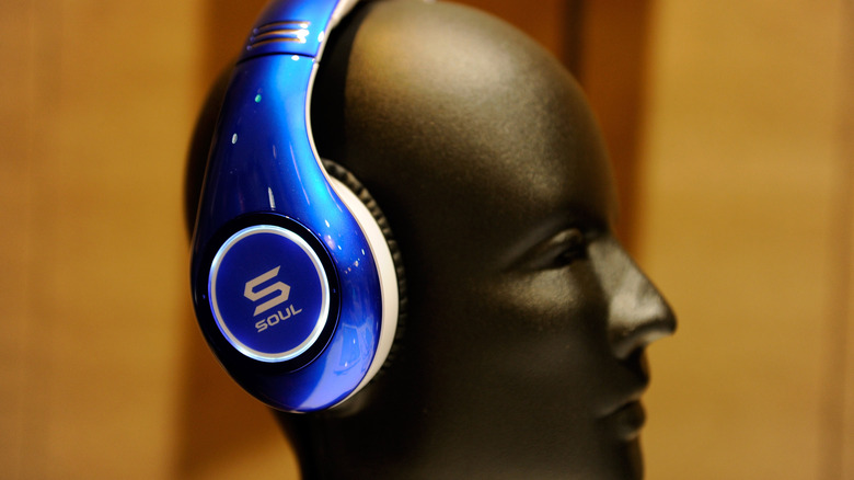 A pair of noise cancelling headphones on a mannequin head.