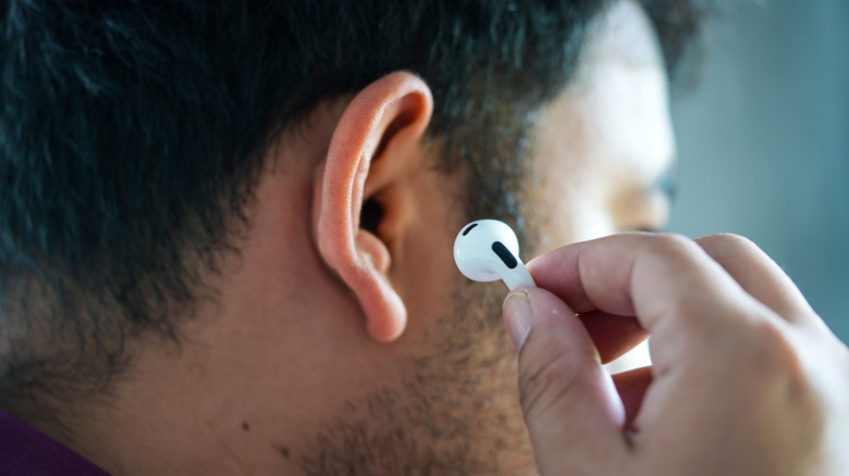 A man putting AirPods in his ears