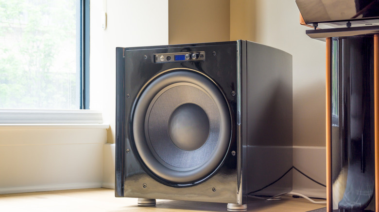 An active subwoofer placed near an entertainment center.