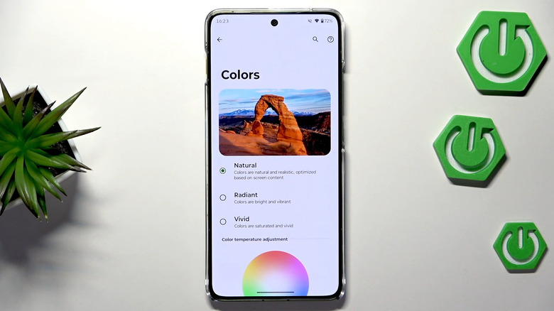 A Motorola Edge 70 on an off-white surface showing color modes