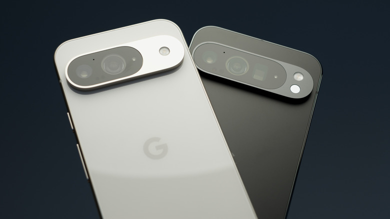 A Google Pixel 9 and Pixel 9 Pro XL Android smartphones in white and black on a dark background