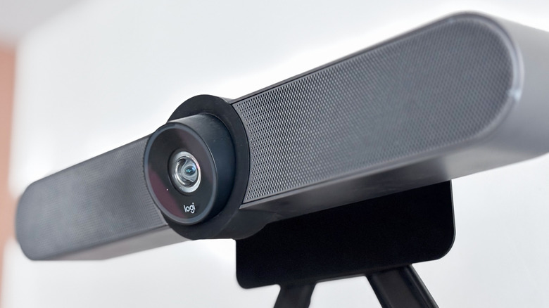 A Logitech webcam and soundbar mounted on a stand