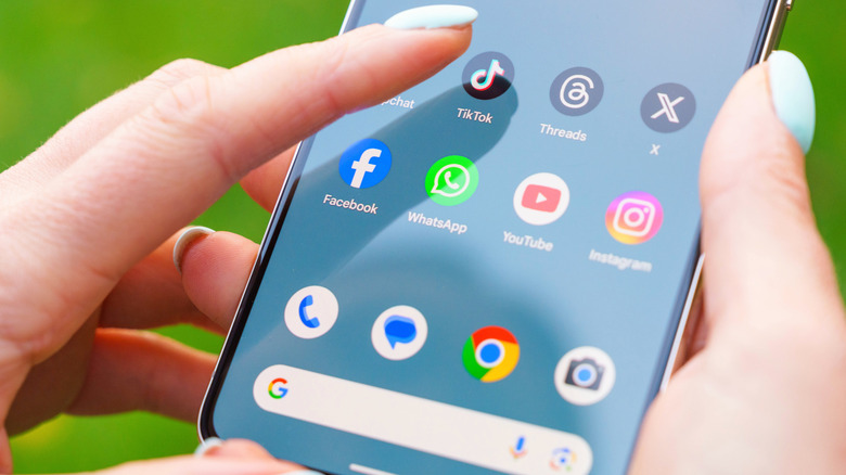 A default Pixel 8 Pro home screen showing a hand interacting with the screen