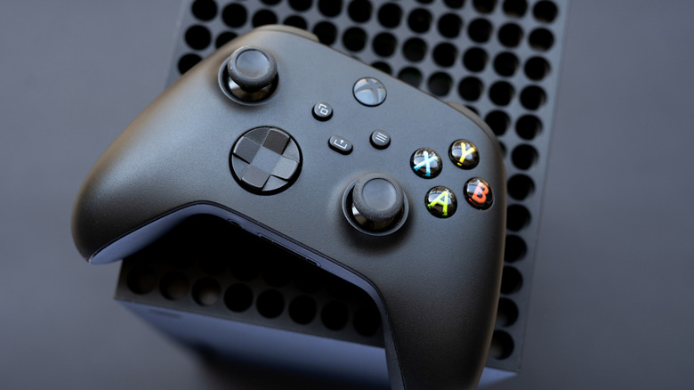 Xbox Series X controller on top of console with black background