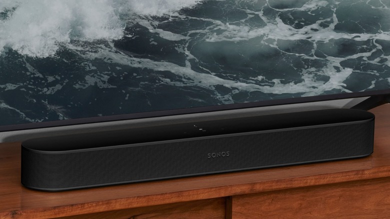 Sonos Beam Gen 2 soundbar in front of TV on wooden stand