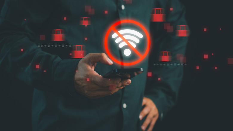 Man holding phone with symbol indicating no internet access