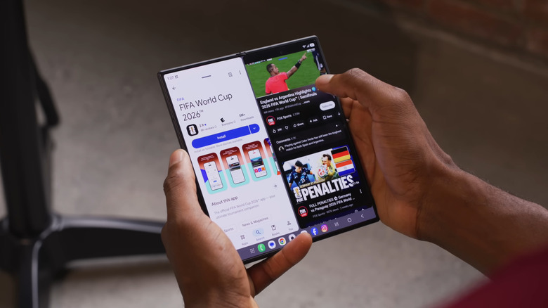 Hand holding Samsung Galaxy Z Fold 8 in split screen mode