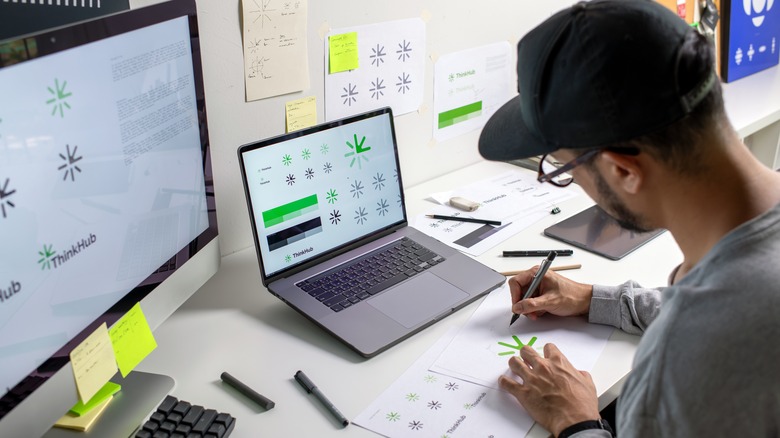 a man working on a graphic design project with software