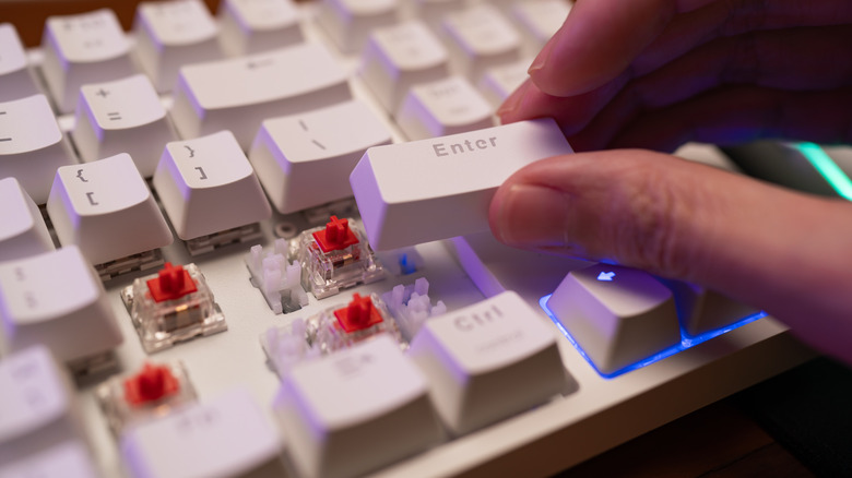 Close-up of a mechanical keyboard with keys removed and switches exposed.