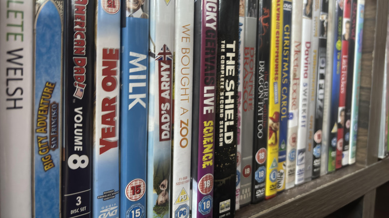 Collection of DVDs and Blu-rays stored upright on a shelf.