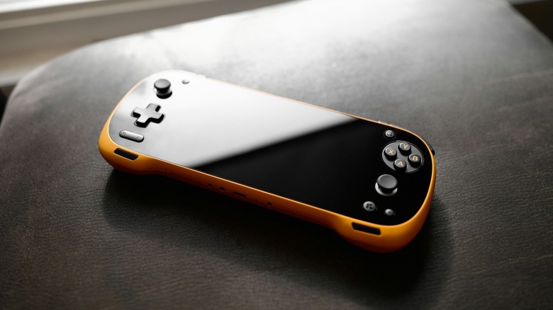Portable gaming console with orange trim.