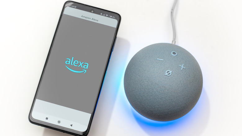 A smartphone displaying the Alexa logo next to an Echo device