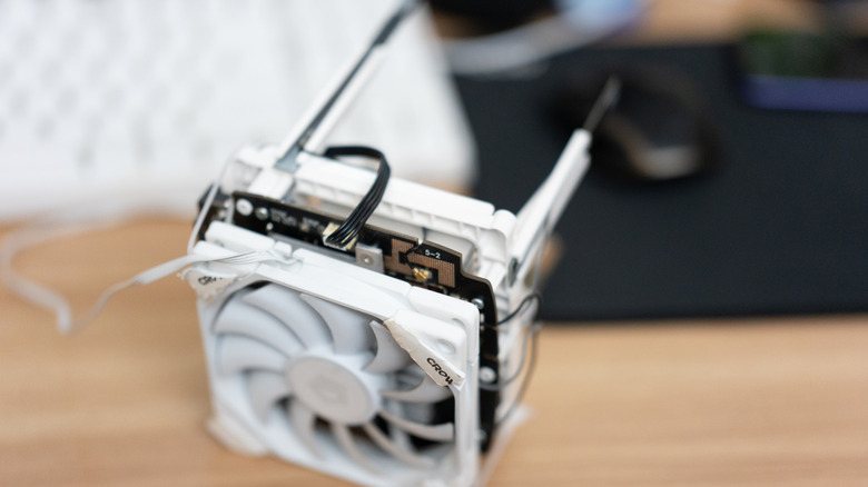 A small fan connected to a router for better heat dissipation