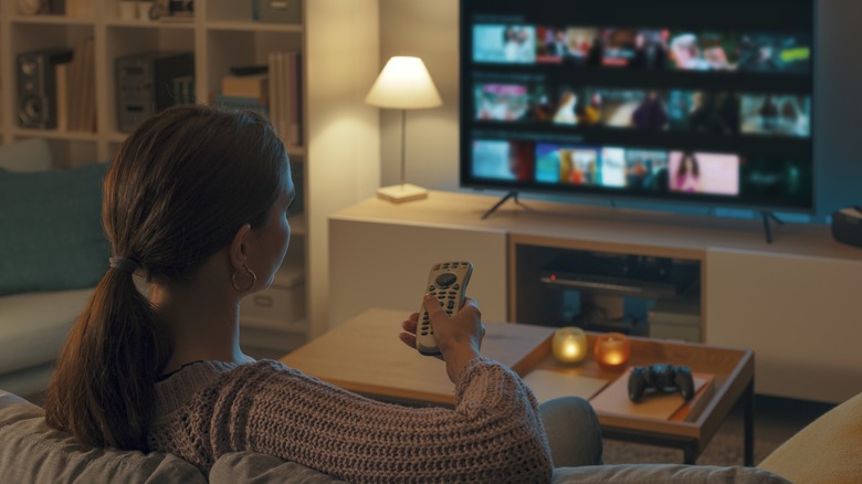 A person relaxing on the couch while watching TV