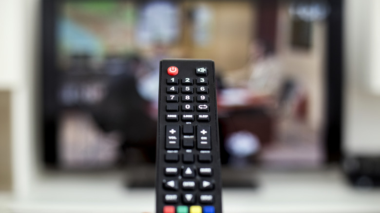 A remote control being aimed at a TV.
