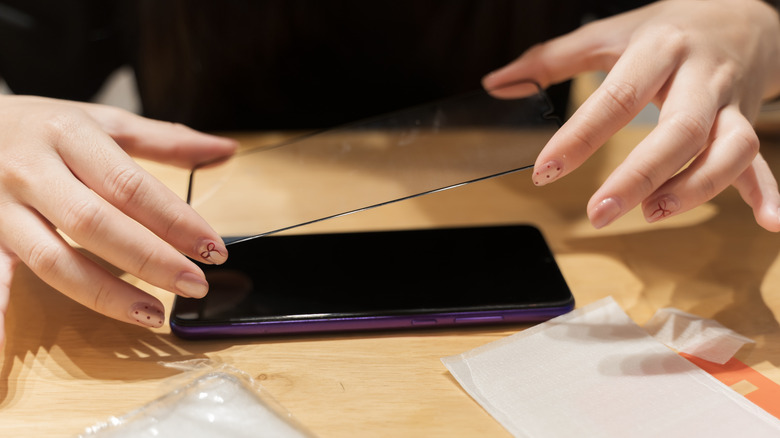 Installing a screen protector on a phone
