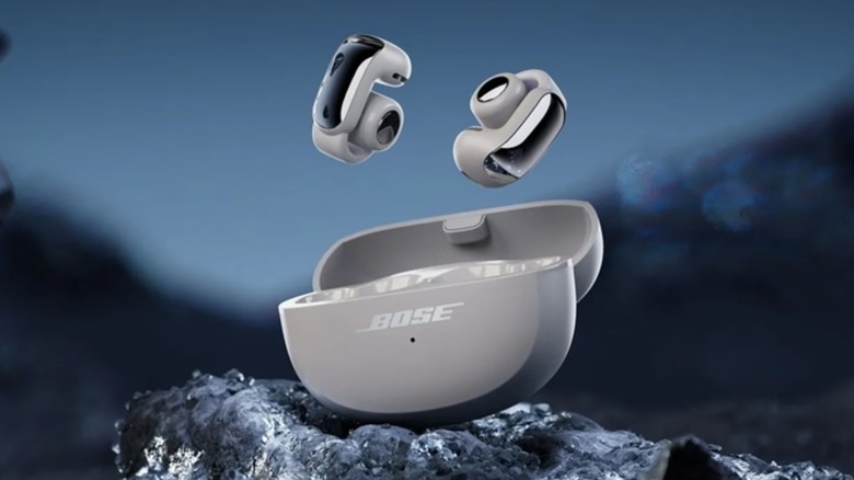 Gray Bose Ultra Open Earbuds floating above charging case