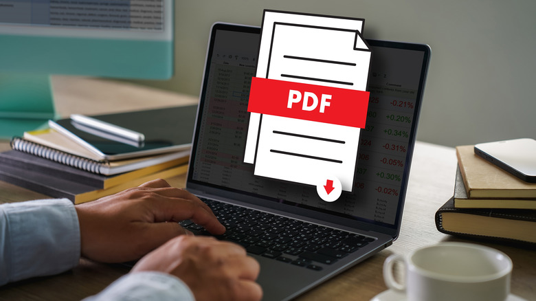 A person working on a laptop with a PDF file icon in the foreground