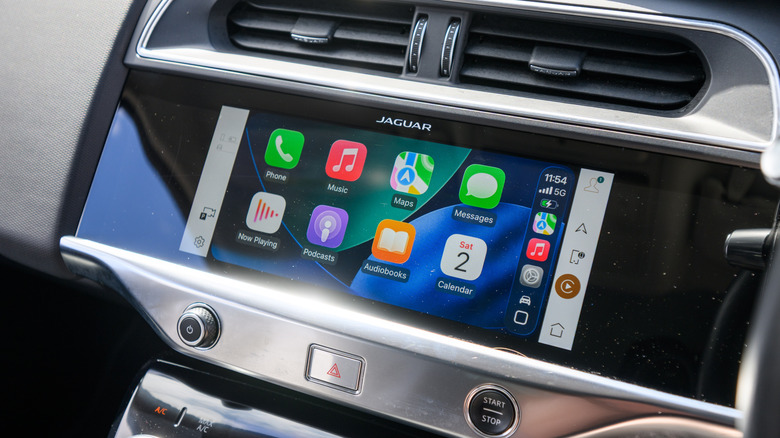 A shot of a Jaguar's infotainment screen displaying several CarPlay apps