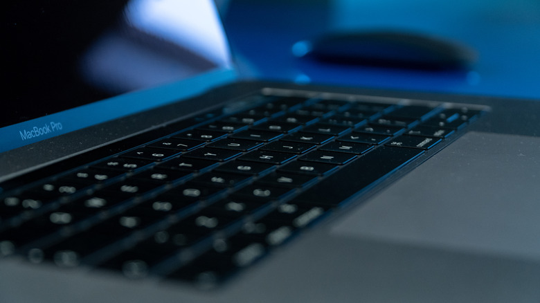 A close-up of a dusty MacBook Pro keyboard