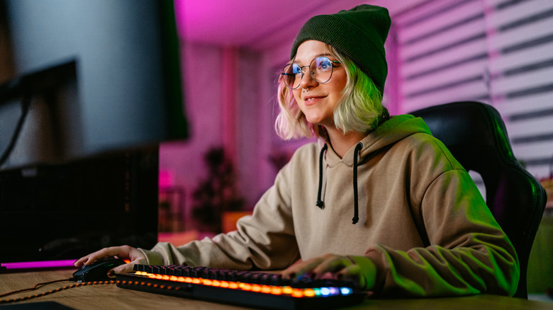 A young woman looking at her computer monitor