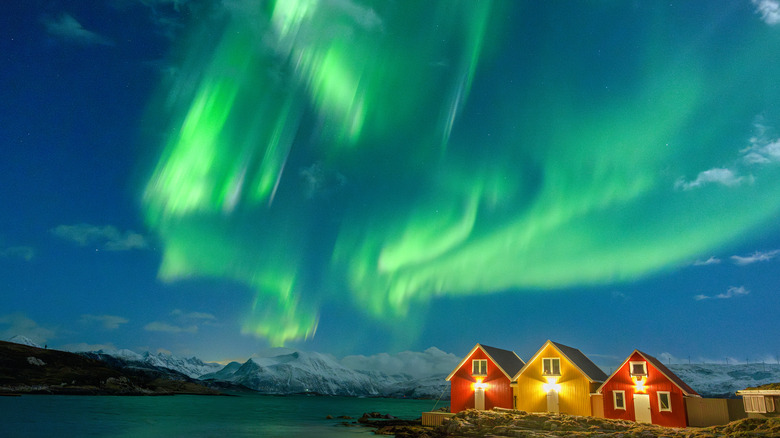 Aurora borealis over cabins in Norway